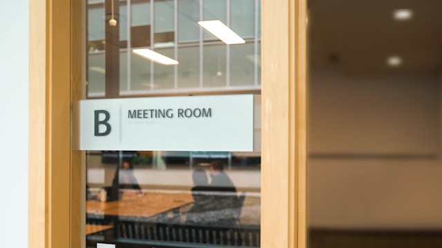 Source: Unsplash. Meeting room sign