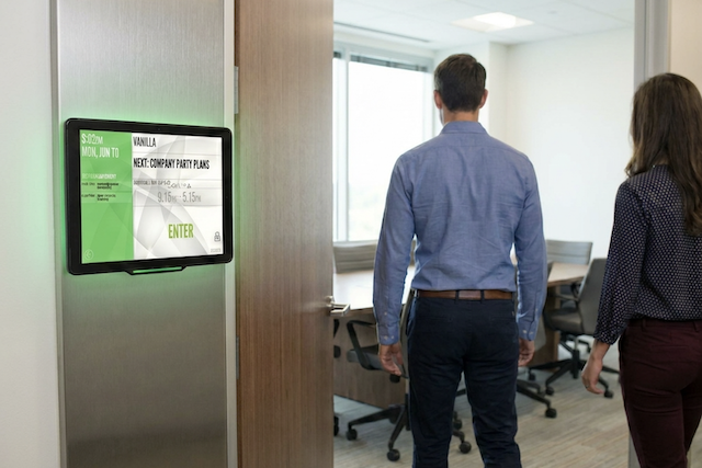 People booking a meeting room with Door Tablet Room Booking System